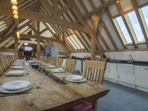 a large wooden table in a kitchen with wooden beams at The Roundhouse in Halwell