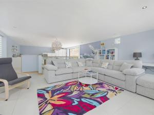 a living room with a couch and a table at 5 Beachdown in Bigbury