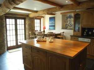 a kitchen with a wooden island in a room at East Bickleigh in Totnes