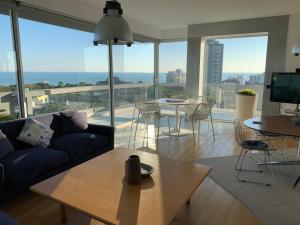 a living room with a couch and a table at Penthouse Bellavista in Lignano Sabbiadoro