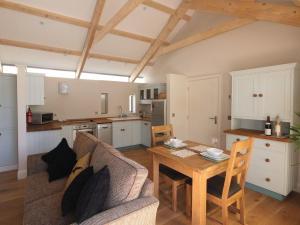 a living room with a couch and a table at Mugwell Barn in Callington