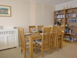 a dining room with a wooden table and chairs at Apartment 66 in Kingsand