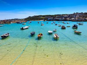 a bunch of boats are in the water at Boundys House in St Ives