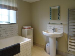 a bathroom with a sink and a bath tub at Kingbarth in Lerryn +12 photos
