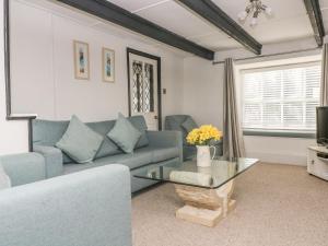 a living room with a couch and a glass table at Boundys House in St Ives