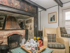 a living room with a fireplace and a chair at Boundys House in St Ives +23 photos