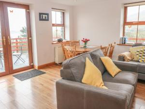 a living room with a couch and a table at Cahirkeen Cottage in Eyeries