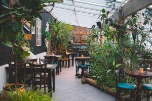 a patio with tables and chairs and plants at Mary-Ann's Polarrigg in Longyearbyen