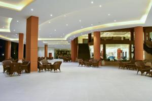 a lobby with a table and chairs in a building at Parrotel Lagoon Waterpark Resort in Sharm El Sheikh