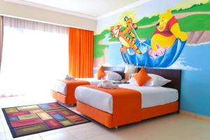 Parrotel Lagoon Waterpark Resort tesisinde bir odada yatak veya yataklar