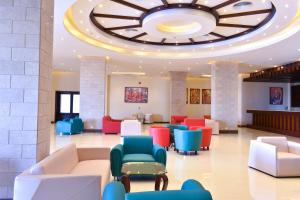 a lobby with colorful chairs and a large ceiling at Parrotel Lagoon Resort in Sharm El Sheikh