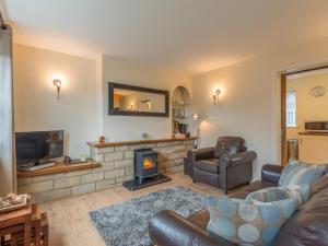 a living room with a couch and a fireplace at Crumstone Corner in Seahouses