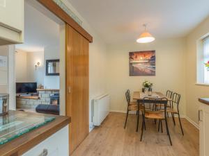 a kitchen and dining room with a table and chairs at Crumstone Corner in Seahouses