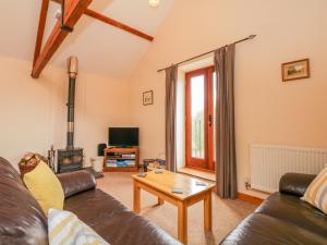 a living room with a couch and a coffee table at The Old Stable in Sidbury