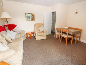 a living room with a couch and a table at Gwern Tyno in Colwyn Bay