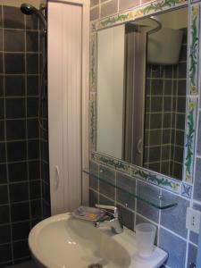 a bathroom with a sink and a mirror at Villino with Garden in Tropea