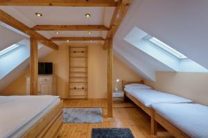 2 camas en un dormitorio en el ático con tragaluces en Romance Ubytování, en Jindřichův Hradec