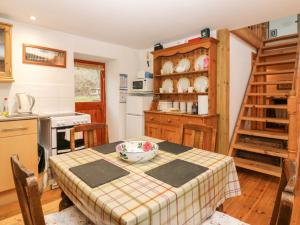 a kitchen with a table with a bowl on it at Creag Mhor Cottage in Dornie