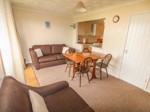 a living room with a table and a couch at Surf in Hunstanton