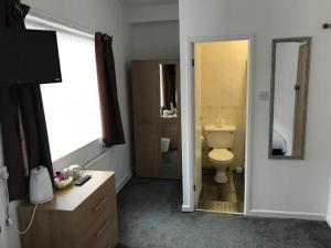 ein Badezimmer mit Toilette, Waschbecken und Spiegel in der Unterkunft The Orbiston in Blackpool