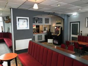 a restaurant with a red bench and a bar at The Orbiston in Blackpool