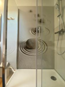 a glass shower door with a stove in a bathroom at La VILLA en BAIE in Le Crotoy +70 photos