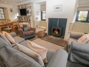 a living room with a couch and a fire place at Barney's Cottage in Ambleside