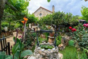 a garden in front of a house with flowers and plants at Dimitris's Country House in Ayiá