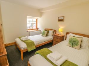 Uma cama ou camas num quarto em Little Byre Cottage