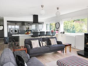 a living room with a couch and a kitchen at Manor House in Warkworth