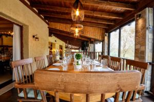 a dining room with a long table and chairs at Archontiko Liamas in Stavros