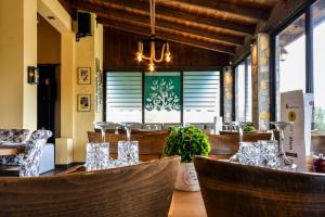 a restaurant with chairs and a table with glasses at Archontiko Liamas in Stavros