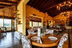 a dining room with a wooden table and chairs at Archontiko Liamas in Stavros