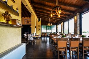 a restaurant with wooden ceilings and tables and chairs at Archontiko Liamas in Stavros