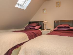 two beds sitting next to each other in a bedroom at Temple Mews in Stow on the Wold