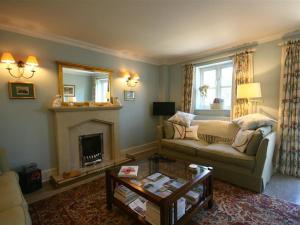 a living room with a couch and a fireplace at Batemans in Nailsworth