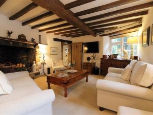 a living room with a couch and a coffee table at Pike Cottage in Stow on the Wold