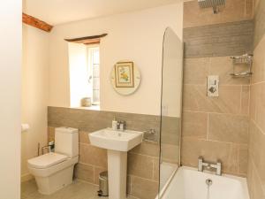 a bathroom with a sink and a toilet and a shower at Bull Cottage in Burford +32 photos