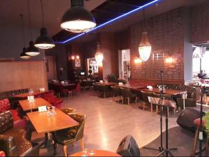 a dining room with tables and chairs and lights at FALCON PALAs OTEL in Istanbul