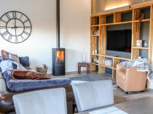 a living room with a couch and a fire place at Ash Bank, Jacobs Wood in Keighley