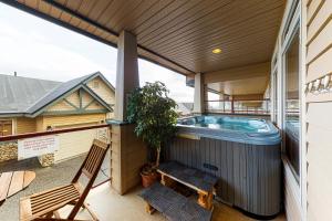 a patio with a hot tub on a house at Tree Tops in Big White