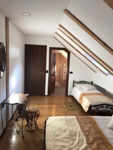 a bedroom with a bed and a table and chairs at Four S Palace in Băile Borşa +69 photos