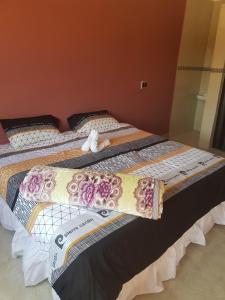 two twin beds with a stuffed animal laying on them at Glenmore Guest house in Durban