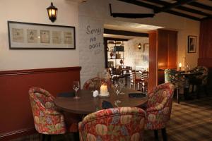 a dining room with a table and chairs and a restaurant at The Rising Sun in Coltishall