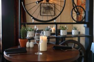 a wooden table with a wine glass and plants on it at The Rising Sun in Coltishall