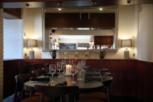 a dining room with a table with wine glasses at The Rising Sun in Coltishall