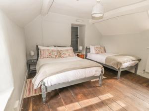 a bedroom with two beds in a room at College Cottage in Corwen