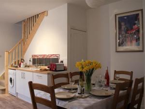 a table with chairs and a kitchen with a dining room at Greencroft View, SALISBURY in Salisbury