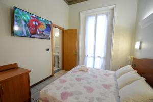 Un pat sau paturi într-o cameră la Soana City Rooms