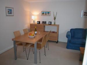 a dining room with a table and a blue chair at Charter Court in Salisbury